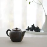 Full side view of antique style handcrafted chinese clay teapot