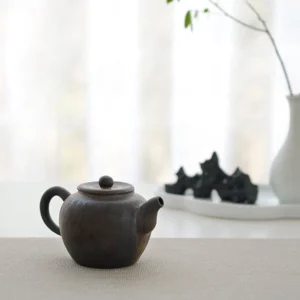 Full side view of antique style handcrafted chinese clay teapot