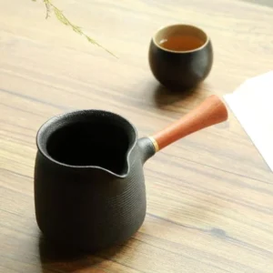 black ceramic horizontal stripe gong dao bei tea pitcher with wood handle side view