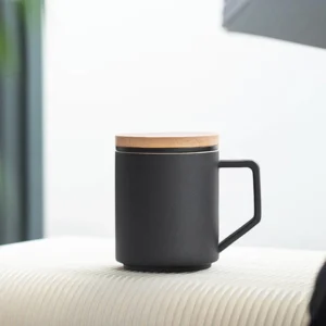 black ceramic tea mug with infuser and wooden lid side view