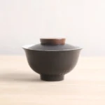 hammered textured black and white ceramic gaiwan with wood accent front view