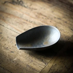 rustic ceramic iron-imitating tea scoop on bamboo tea tray