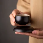 handcrafted chinese black clay tea cup and saucer set with textured matte finish