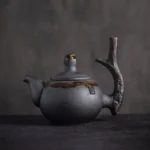 full view of handcrafted 8.1oz chinese black clay zen teapot with branch handle