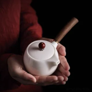full view of handmade chinese white ceramic kyusu teapot with wooden side handle