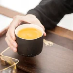 matte black chinese tea cup with fu character lotus relief overall view