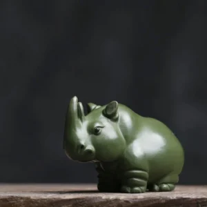 front view of cute green clay rhinoceros tea pet