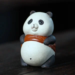 Handmade panda purple clay tea pet front view on white background