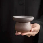 handmade dark brown ceramic tea strainer with stand main view