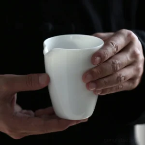 full view of Dehua mutton fat jade porcelain gong dao bei creamy white tea pitcher