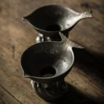 handcrafted fish shape metal tea strainer full product view on wooden tea table