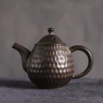 front view of small unique honeycomb textured chinese ceramic teapot
