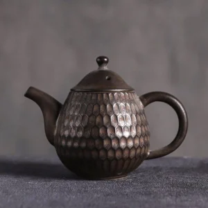 front view of small unique honeycomb textured chinese ceramic teapot