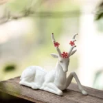 full collection of three styles of handcrafted ceramic deer tea pet on wood tea table