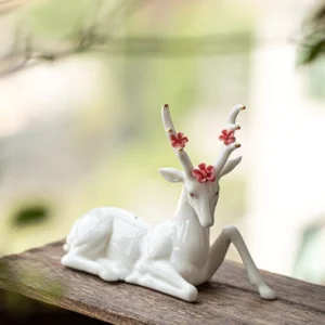 full collection of three styles of handcrafted ceramic deer tea pet on wood tea table