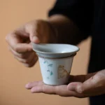 full set view of hand painted ceramic chinese cat tea strainer with gong dao bei and tea cup
