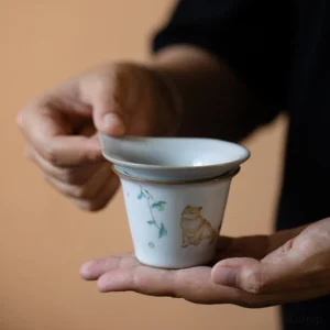 full set view of hand painted ceramic chinese cat tea strainer with gong dao bei and tea cup