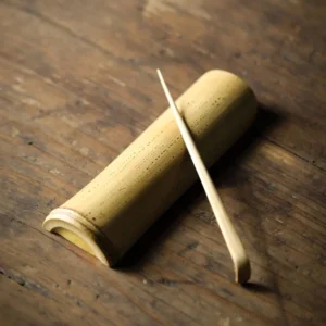 full set of handcrafted natural mottled bamboo tea scoop and tea needle on wood background