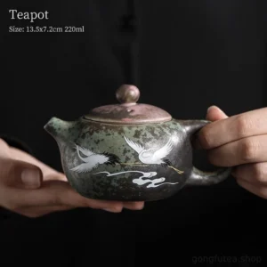 full side view of hand-painted crane and cloud vintage chinese gongfu teapot