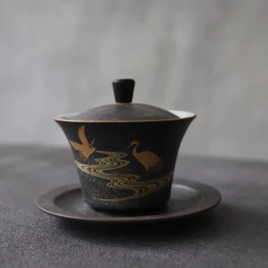 full view of traditional hand painted black gold crane ceramic gaiwan