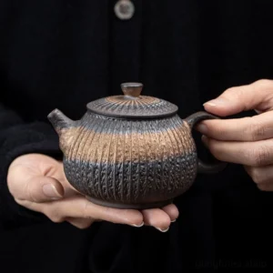 Handcrafted gilded iron glaze Chinese teapot with vertical rustic texture main view