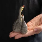 gray mother and baby goose color changing ceramic tea pet close up