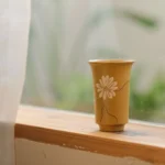 hand painted yellow chinese zisha tea cup 1.2oz with daisy pattern side view