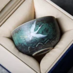 side view of hand painted lotus crane ceramic chawan tea cup