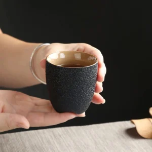 Handcrafted rustic black clay chinese tea cup side view