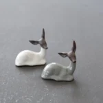 handcrafted ceramic deer tea pet resting on wooden tea table