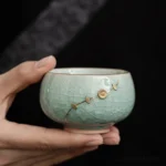 Handcrafted ice crack green ceramic chawan tea bowl with gold floral decoration