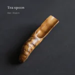 handcrafted natural bamboo root tea scoop displayed on black background