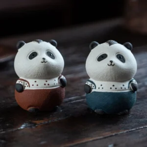 handcrafted purple clay cute panda tea pet on wooden tea table