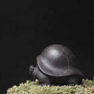 handcrafted purple clay turtle tea pet on tea table, chinese traditional tea pet