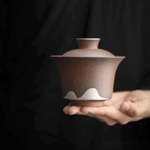 full view of handcrafted rustic clay gaiwan tea set with mountain design