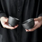 collection of handcrafted textured black ceramic chawan tea bowls multiple sizes