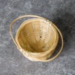 Handmade natural bamboo woven tea strainer on wooden table