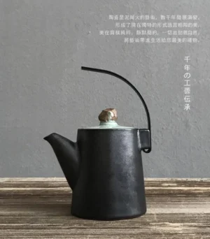 Handmade black ceramic chinese teapot with metal lift handle, front view