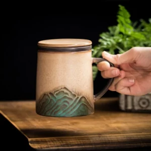 handmade ceramic tea mug with mountain relief tea strainer and lid full product view