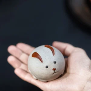 front view of handmade cute rabbit ceramic tea pet for tea table decor