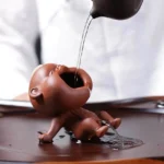 full side view of handmade zisha peeing boy tea pet
