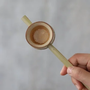 handmade small natural bamboo tea strainer on wooden tea tray