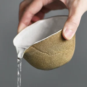 pouring test of handmade textile burnt ceramic gong dao bei tea pitcher