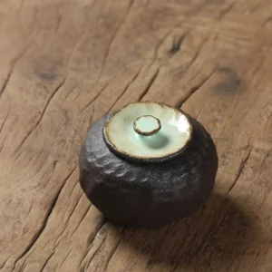 handmade textured ceramic tea canister with pale celadon lid side view