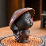 cute ceramic boy tea pet with matching tea strainer cap main view
