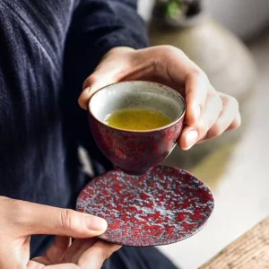 collection of handcrafted iron rust glaze chinese tea cups with matching saucers