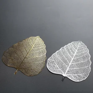 Leaf shape stainless steel tea strainer displayed on wooden background