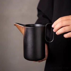 full view of matte black ceramic gong dao bei tea pitcher on neutral background