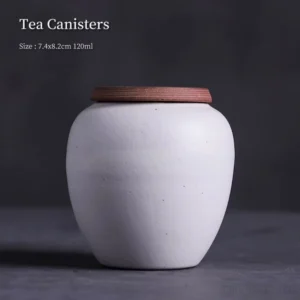 front view of mini white clay tea canister with brown lid