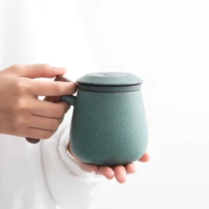 minimalist ceramic tea mug with infuser and wooden handle main view